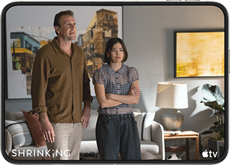 iPhone Duo, opened in horizontal position, Apple TV show "Shrinking" plays on screen