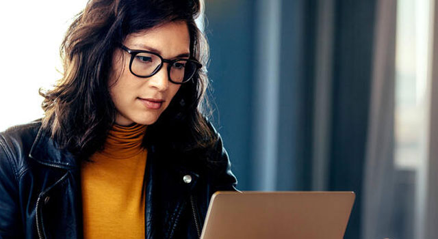 A lady looking at the laptop